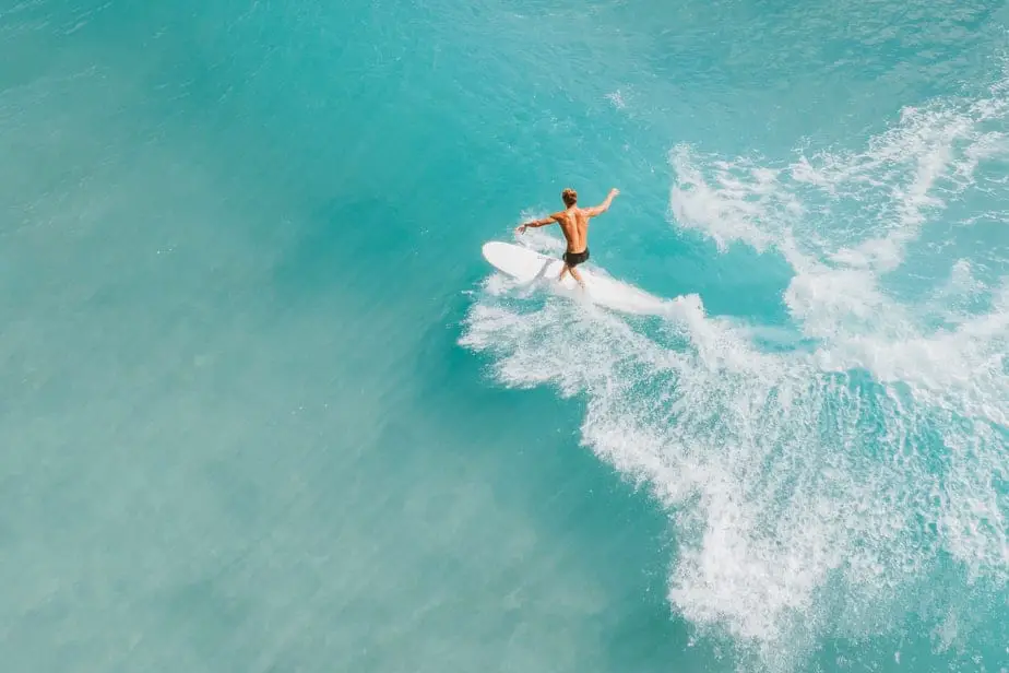 shirtless surfer behind