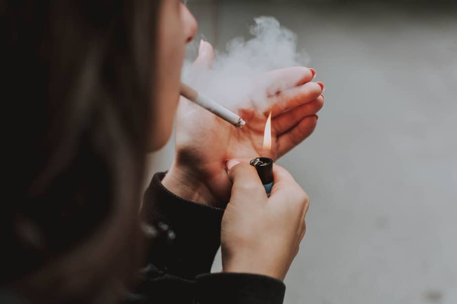 woman smoking cigarette back view