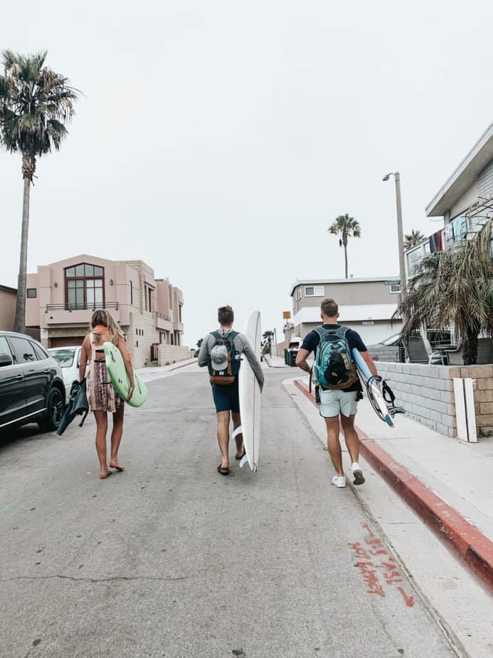 surfers walking as a group