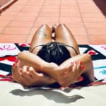 How to Get Tanning Oil Out of Bathing Suit