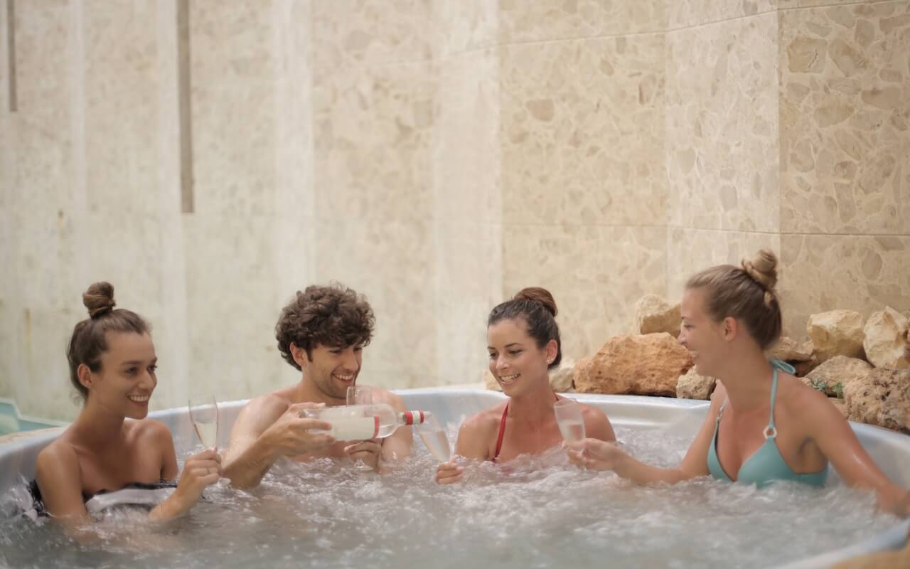 group of friends socializing in hot tub