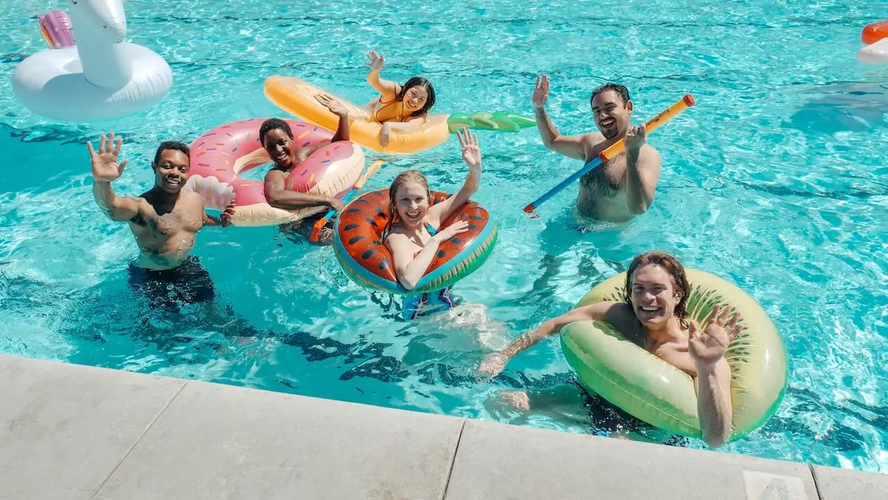 people in pool with pool floats