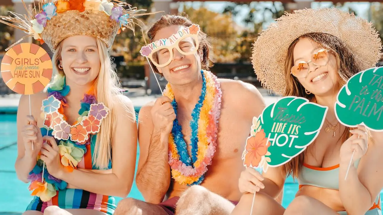 a man and two women at a pool party