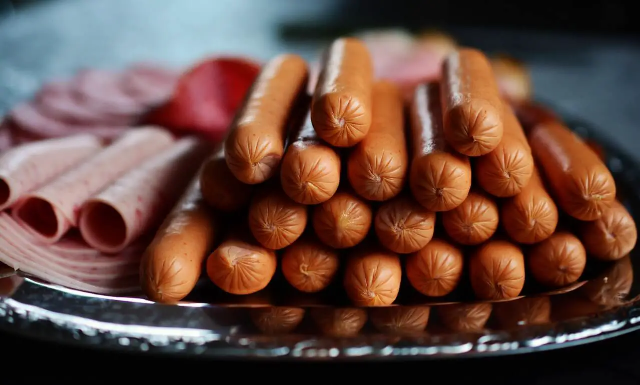 platter of processed meats hot dog ham