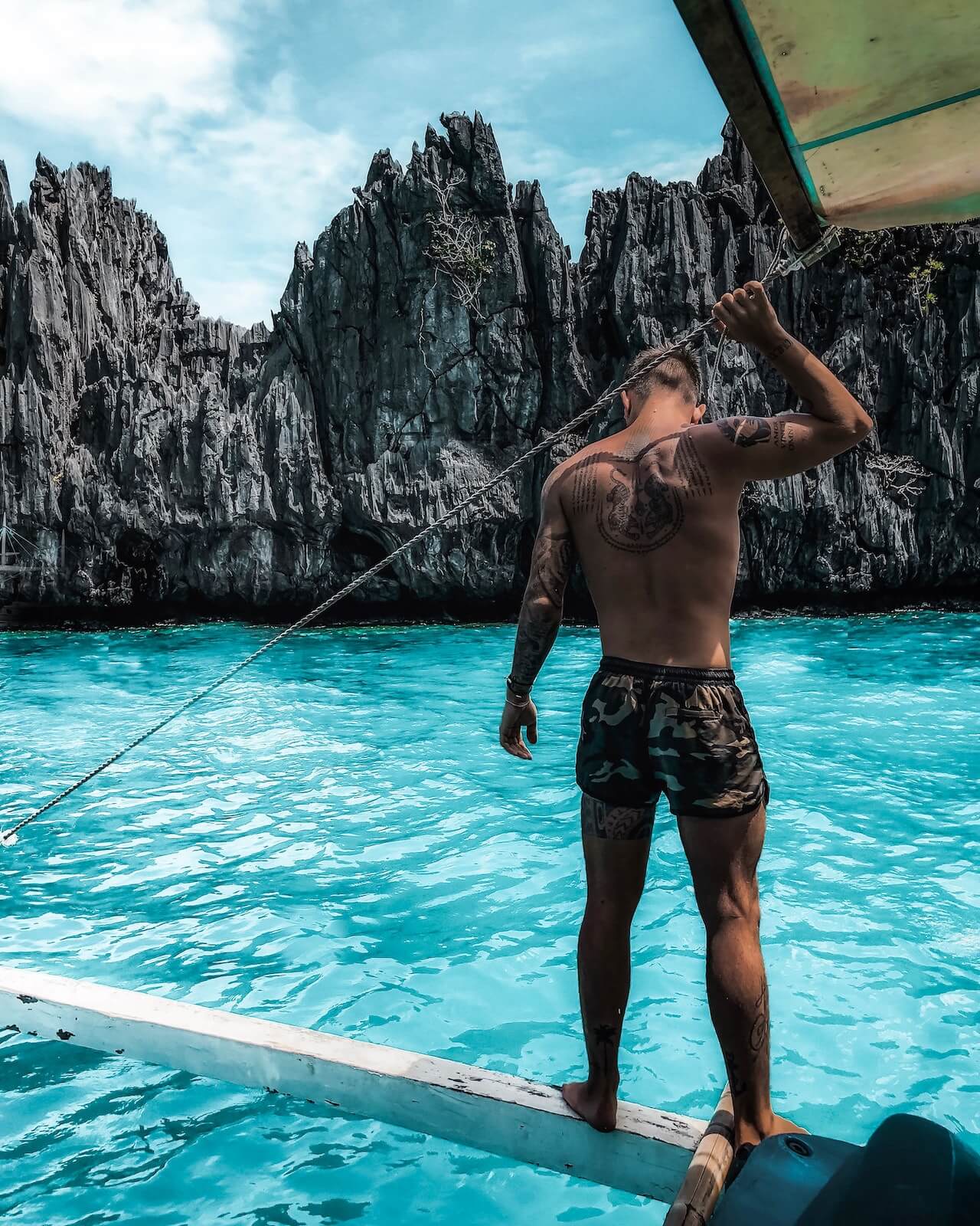 tattooed man on a boat in the ocean