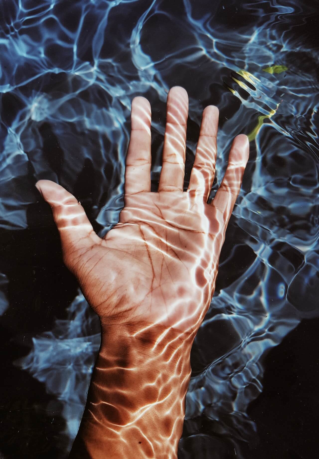 open hand submerged in water