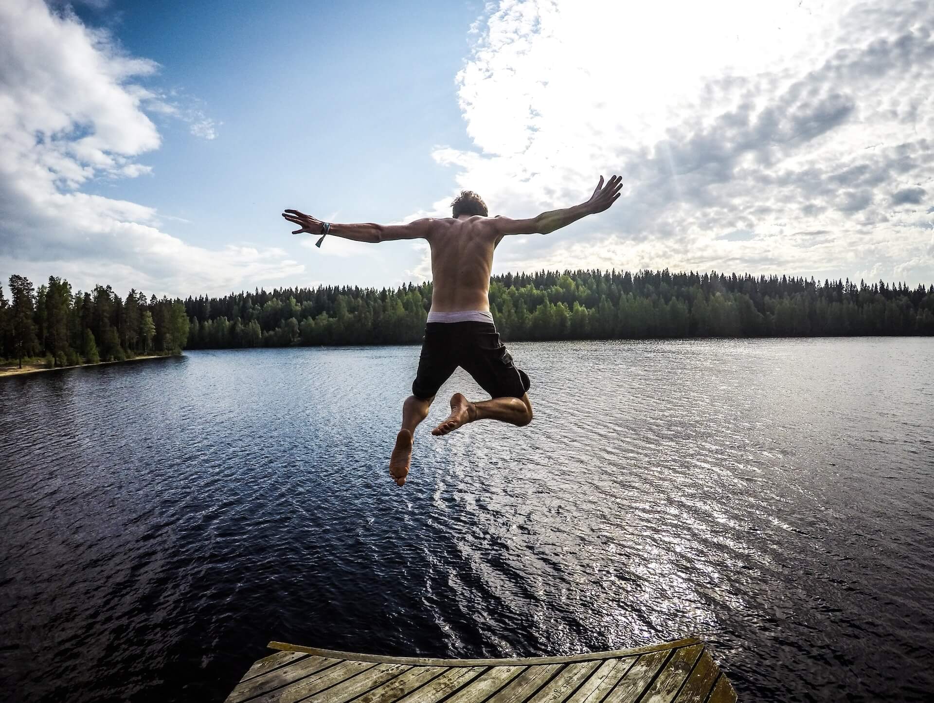 guy jumping into lake