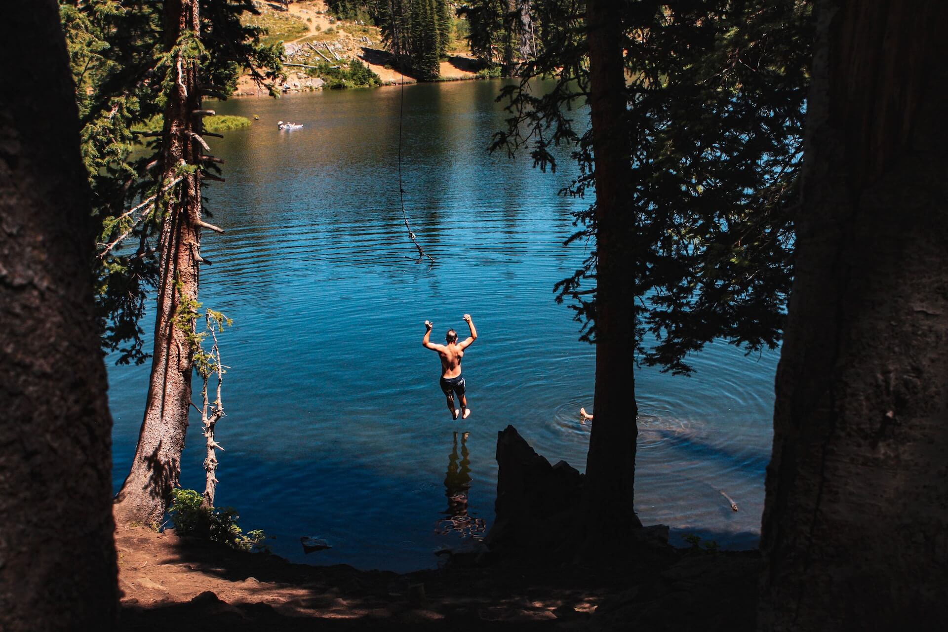 guy swinging into lake