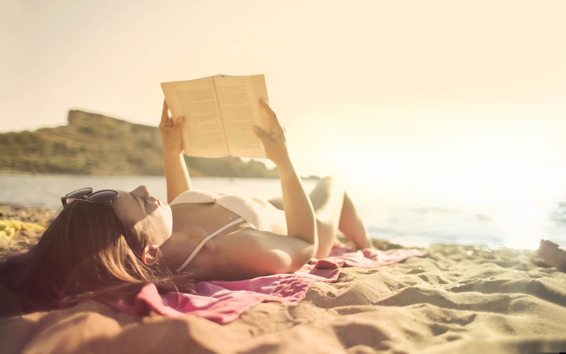 sunbathing while reading a book