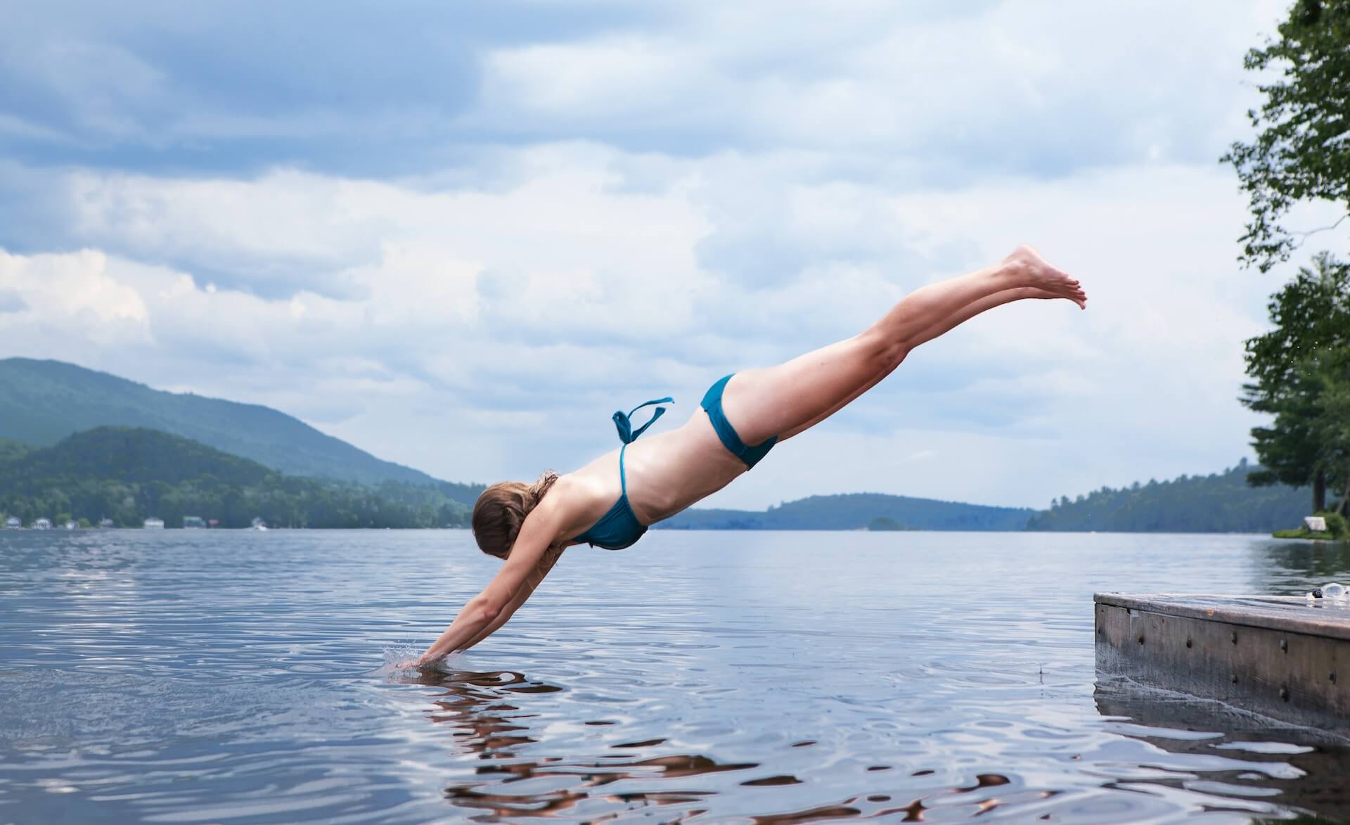 woman diving into lake