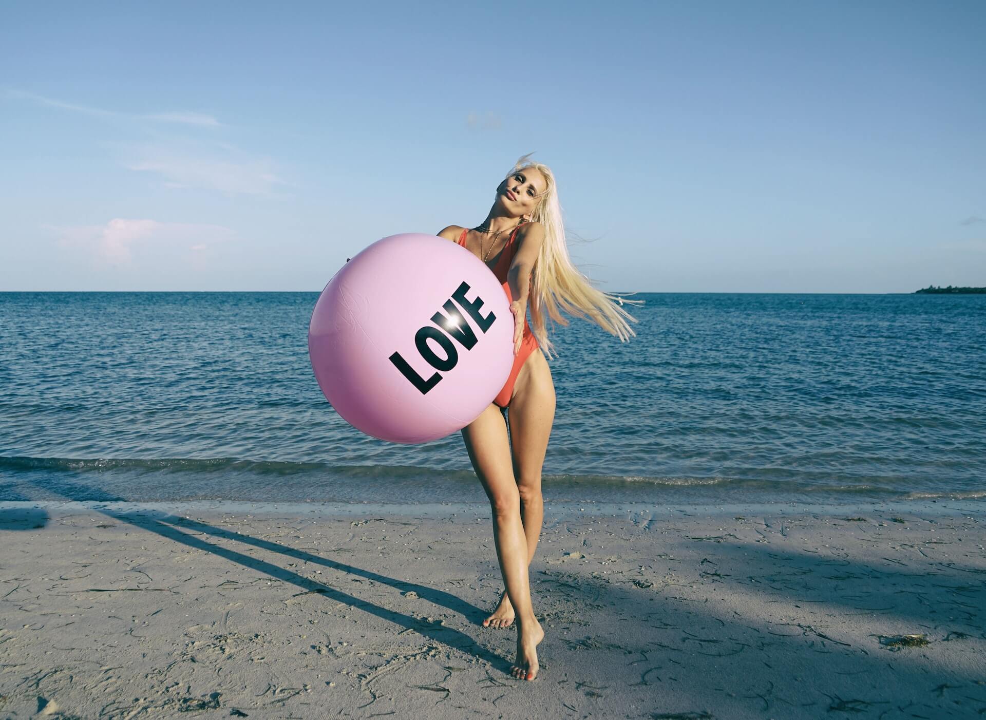 woman holding love beach ball